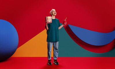 Vibrant image to promote cinema for young audience. Laughing young girl with popcorn and drink...