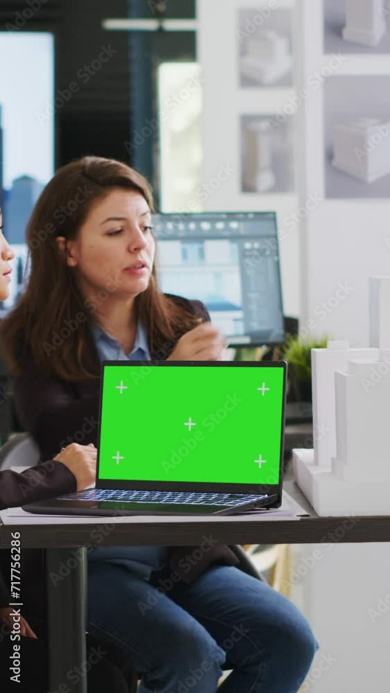 Poster vertical video team of architects working with greenscreen layout on pc, planning new building proje