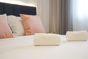 Clean towels on bed in modern interior bedroom	