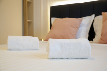 Clean towels on bed in modern interior bedroom	