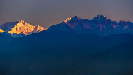 A view of Snow clad Kangchenjunga, also spelled Kanchenjunga,the third highest mountain in the world, at the time of Sunrise.