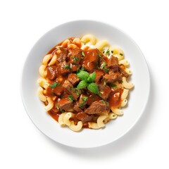 A plate with Goulash on a white plate top view isolated on a white background
