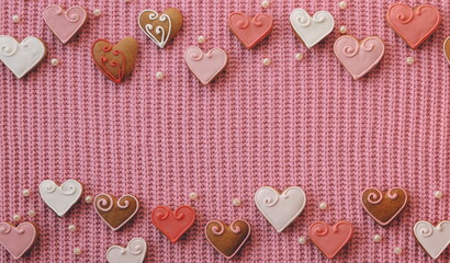 Heart-Shaped Cookies on a Pink Fabric Sweater. A love decoration. Valentine's Day background. View...