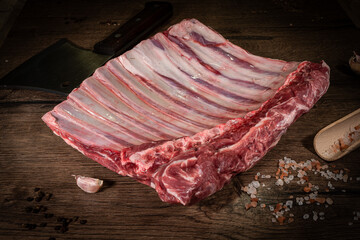Steak, ribs, fresh meat on a wooden board