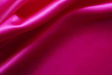 Pink silk or satin background, wavy, elegant and elegant. Close-up, background. Space for designblur or blurry