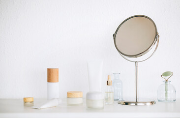 Cosmetic products and mirror on table