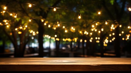 Empty wood table top with decorative outdoor string lights hanging on tree at night - obrazy, fototapety, plakaty