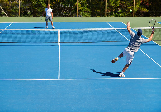 Tennis, game and men with fitness, friends and competition with training and exercise with sunshine. Players, tournament and guys with rackets and court with workout and challenge in the summer