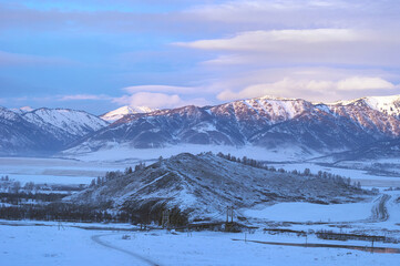 Fototapeta na wymiar Cold snowy mountain landscape at sunset.