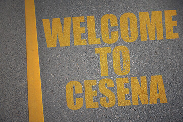 asphalt road with text welcome to Cesena near yellow line.