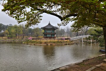 Fototapeta na wymiar Seoul city landmark in South Korea. Gyeongbokgung Palace complex park pond pagoda pavilion on a rainy weather day.