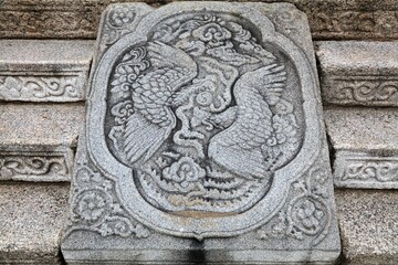 Seoul city landmark in South Korea. Gyeongbokgung Palace complex. Royal Bonghwang phoenix symbol carved in stone.