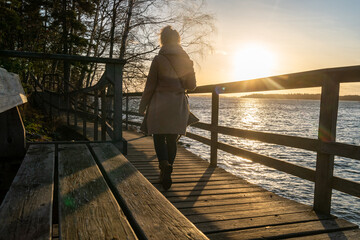Blonde girl on the deck in sunset in mariehamn in aland islands