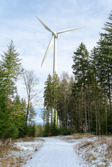 wind turbine in the winter forest on the mountain