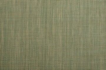 Hessian burlap woven texture background in yellow-green color. Selective focus. Copyspace.