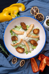 Chicken caesar salad served with fried chicken pieces