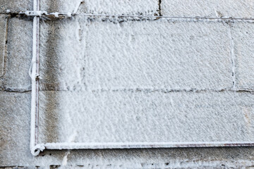 Frozen water after burst from a pipe at the winter.