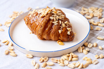 delicious croissant with peanuts and honey