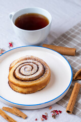 Cinnamon roll served on a ceramic plate