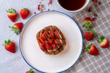 Strawberry and chocolate croissant, cup of tea and fresh strawberries. top view