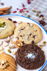 Hazelnut, chocolate and pistachio cookies served on a ceramic tray