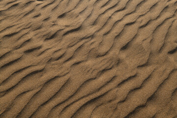 Beautiful sand waves or sand waves caused by the wind. Wind action constantly changes the height,...