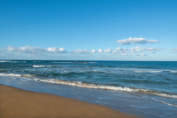 Fototapeta na wymiar Cyprus Alagadi Turtle Beach. View from the beach to the sea. Magnificent beach, sea and blue cloudy sky.