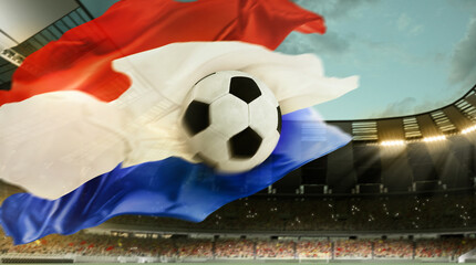 Promotion of sport events worldwide. Soccer ball flying over sports filed with flag of Netherlands symbolizing Netherlands team. Sport fans on background. Concept of championship, tournament, game