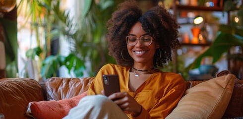 woman sitting on couch with phone in hand
