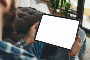 Foto op Canvas cropped view of man holding digital tablet with blank screen at home © ttonaorh