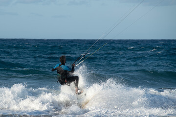 Fototapeta premium Kite surfing.Windsurf.Kite boarding. To fly a kite. Surfers of all ages train in the Mediterranean. Flying a kite on the beaches of Cyprus.
