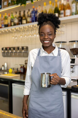 Smiling dark-skinned female barista with a coffee pot