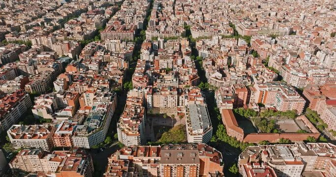 Barcelona, Spain Geometric architecture Eixample residential district sunrise summer drone slide forward. Go Everywhere. Travel. Aerial view residential buildings city blocks and boulevards. Tourism