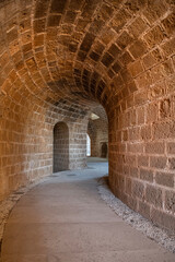Tunnel passages and walls made of cut stone under Othello Castle. Cyprus historical places.