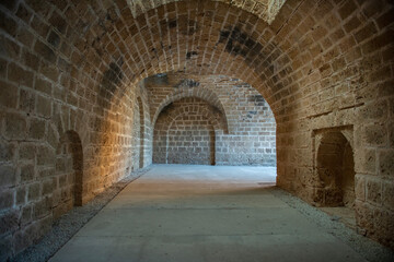 Fototapeta na wymiar Tunnel passages and walls made of cut stone under Othello Castle. Cyprus historical places.