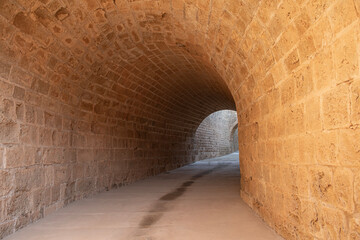 Tunnel passages and walls made of cut stone under Othello Castle. Cyprus historical places.