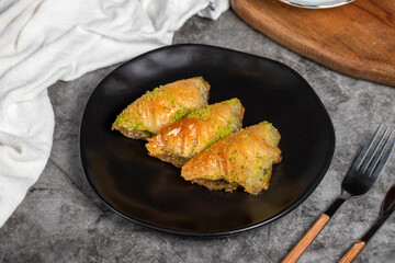 Pistachio baklava. Sobiyet baklava with pistachios on a dark background. Turkish cuisine flavors