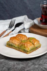 Pistachio baklava. Baklava with pistachios on a dark background. Turkish cuisine flavors