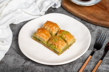 Pistachio baklava. Baklava with pistachios on a dark background. Turkish cuisine flavors