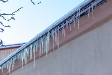 Big icicles on the roof of a townhouse