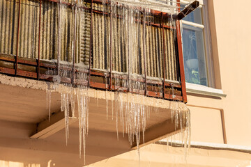 Big icicles on the roof of a townhouse