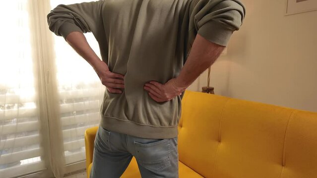 Man with hip, back and sciatica pain at home.