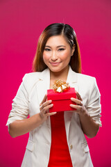 Happy Chinese woman holding a christmas gift.