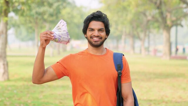 Young Indian Male College Student Money Fan