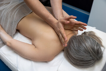 Obraz na płótnie Canvas Close up of female patient having back massage in a clinic