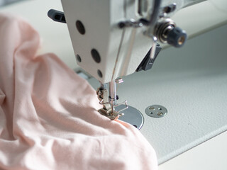 Close up of a sewing process with a clothing item.