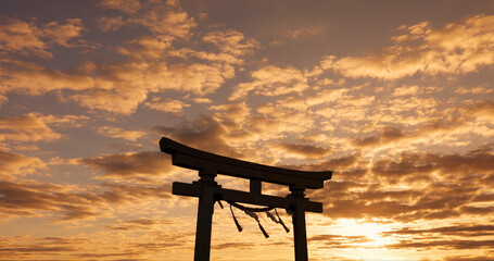 Torii gate, sunset sky in Japan with nature, zen and spiritual history on travel adventure. Shinto architecture, Asian culture and calm clouds on Japanese landscape with sacred monument at shrine.