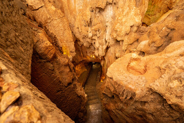 Underground interior of the Coin Cave with lake, stalactites, stalagmites and other rock formations.Vila de Ourém