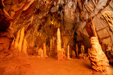 Underground interior of the Coin Cave with lake, stalactites, stalagmites and other rock...