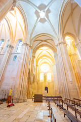 interior of the cloisters of the Batalha monastery seen from the altar. - obrazy, fototapety, plakaty